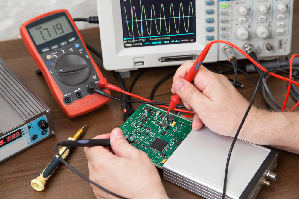 engineer-hands-with-probes-testing-voltage-plate