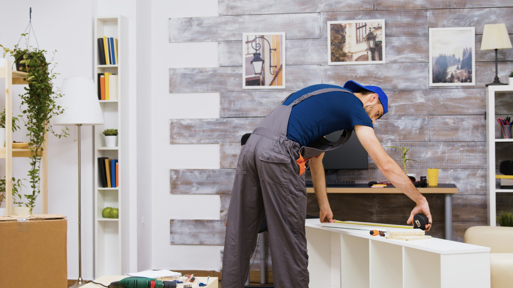 furniture-assembly-worker-standing-reading-instruction-using-tape-measure-worker-tools