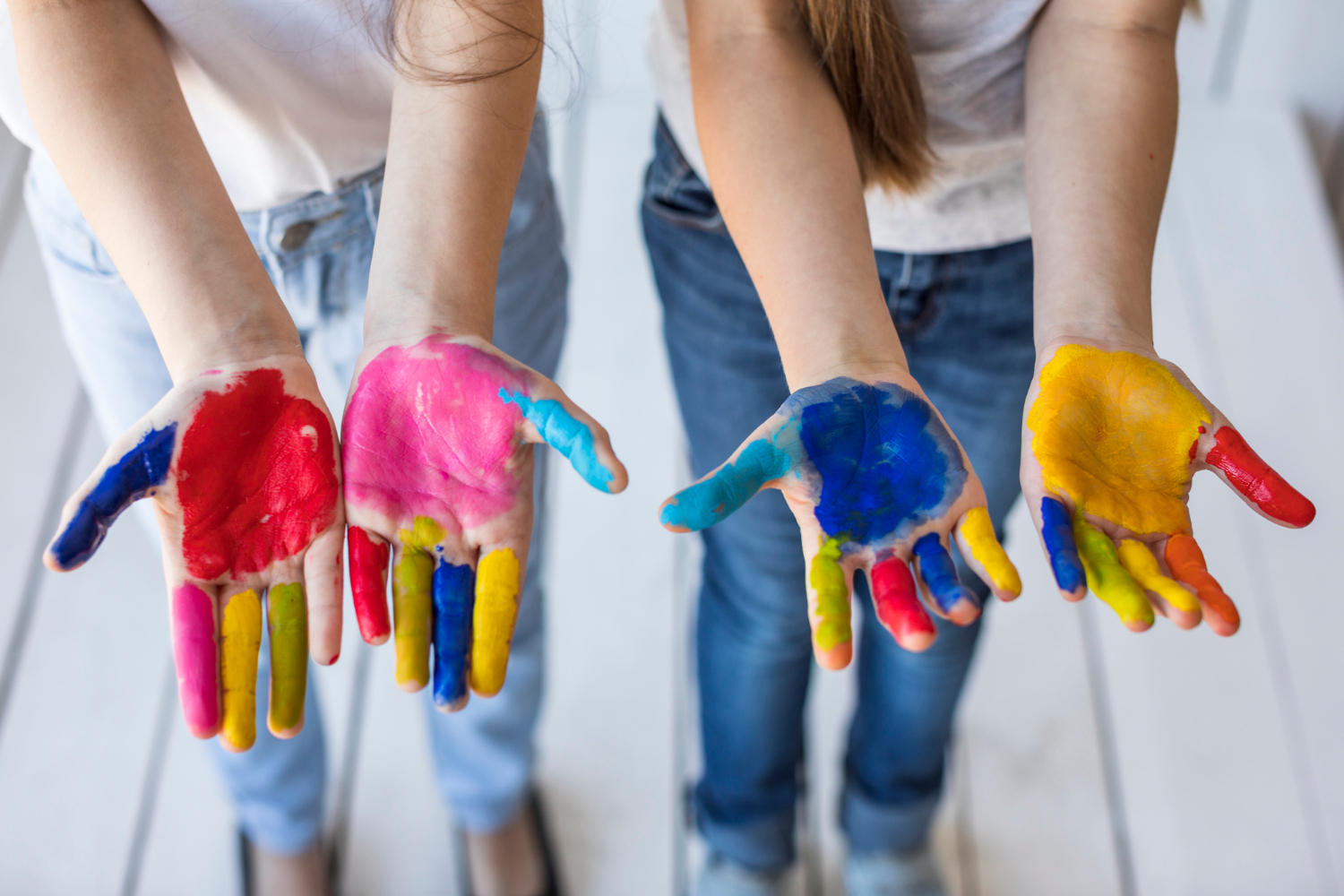 overhead-view-two-girl-s-hand-showing-their-painted-hands