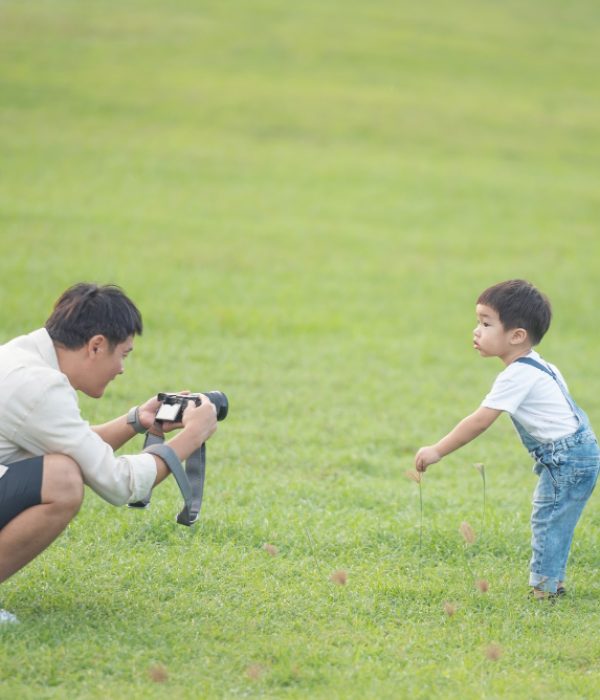 father-with-digital-video-camera-recording-his-son-portrait-happy-father-son-park