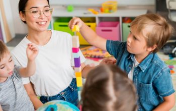 woman-teaching-children-how-play-with-colorful-tower