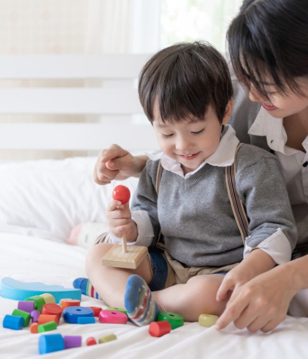 young-mother-playing-with-lovely-son-bedroom