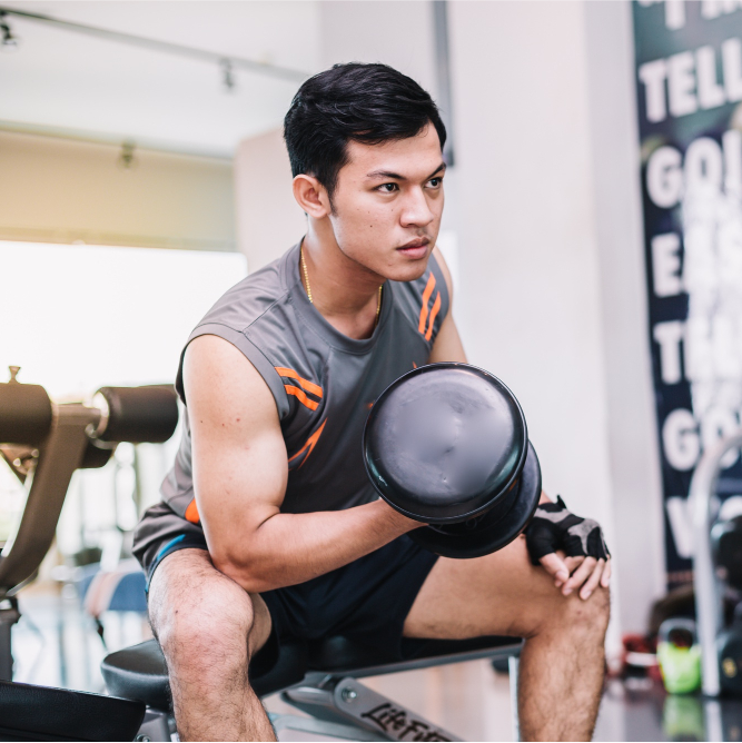 cropped young-bodybuilder-is-exercising-by-lifting-dumbbell-gym