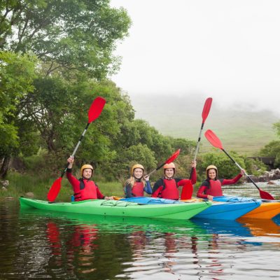 friends-kayaking-together-cheering-camera