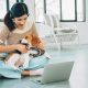 young-freelancer-asian-woman-working-online-via-social-media-with-beagle-dog-using-laptop-home-living-room