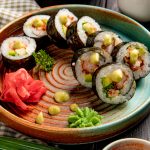 side-vie-sushi-rolls-with-tempura-shrimps-avocado-cream-cheese-plate-with-ginger-wasabi